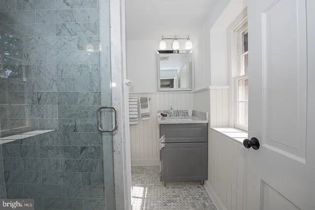 a bathroom with a shower sink and mirror