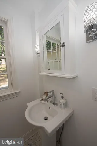 a bathroom with a sink and a window