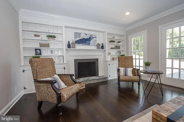 a living room with furniture wooden floor and a fireplace