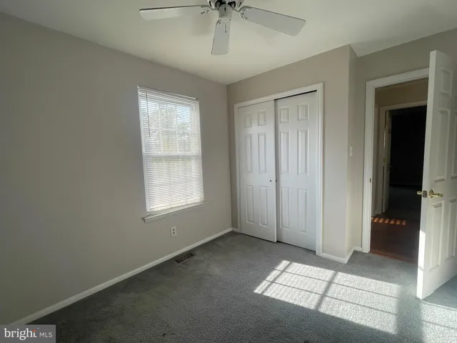 an empty room with windows and closet