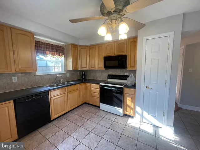 a kitchen with stainless steel appliances a stove sink and microwave