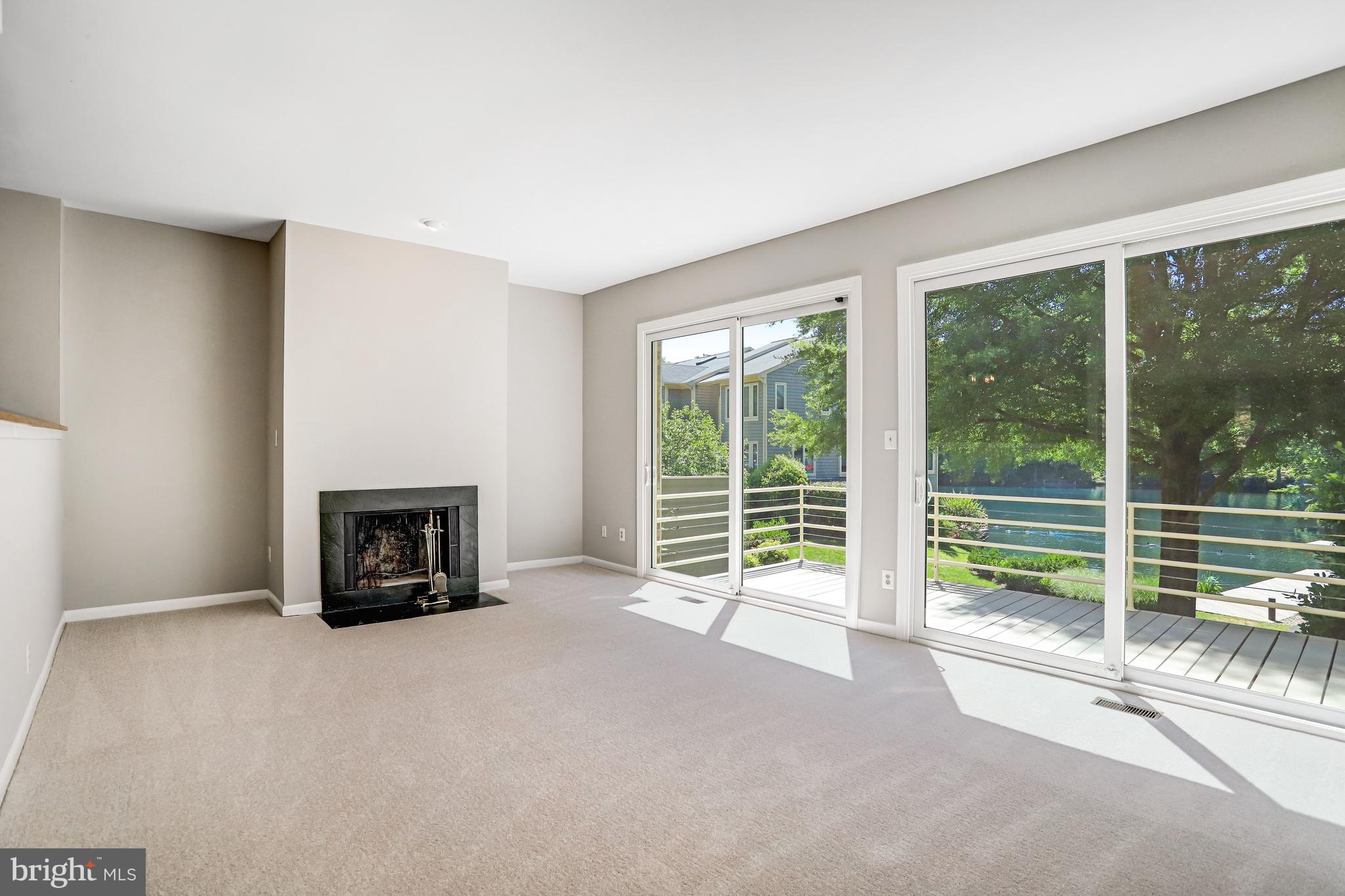 1953 Lakeport Way Reston, VA 20191 - Photo 5 of 60 a view of an empty room with windows a fireplace and a room