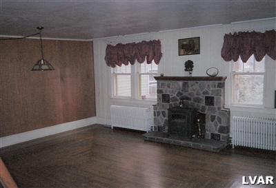 0 Hc Gilbert, PA 18331 - Photo 8 of 17 a living room with furniture and a fireplace