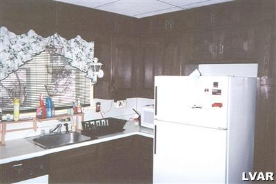 0 Hc Gilbert, PA 18331 - Photo 10 of 17 a white kitchen with a refrigerator and a sink
