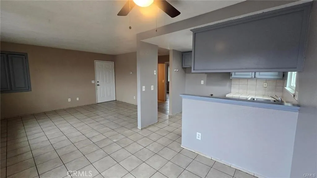 308 North Millard Avenue Rialto, CA 92376 - Photo 8 of 11 a kitchen with kitchen island stainless steel appliances a sink and cabinets
