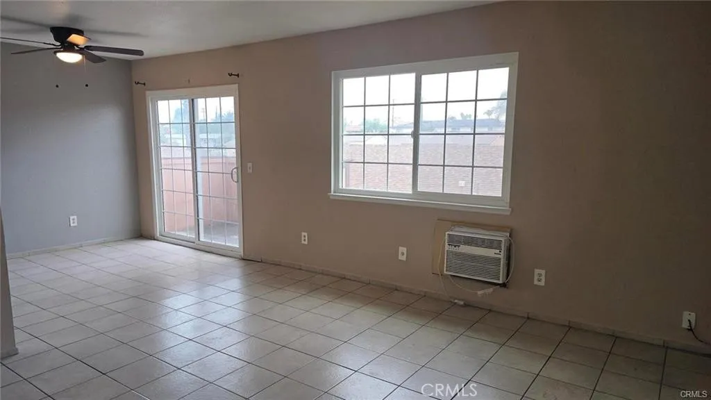 308 North Millard Avenue Rialto, CA 92376 - Photo 9 of 11 an empty room with windows and fan