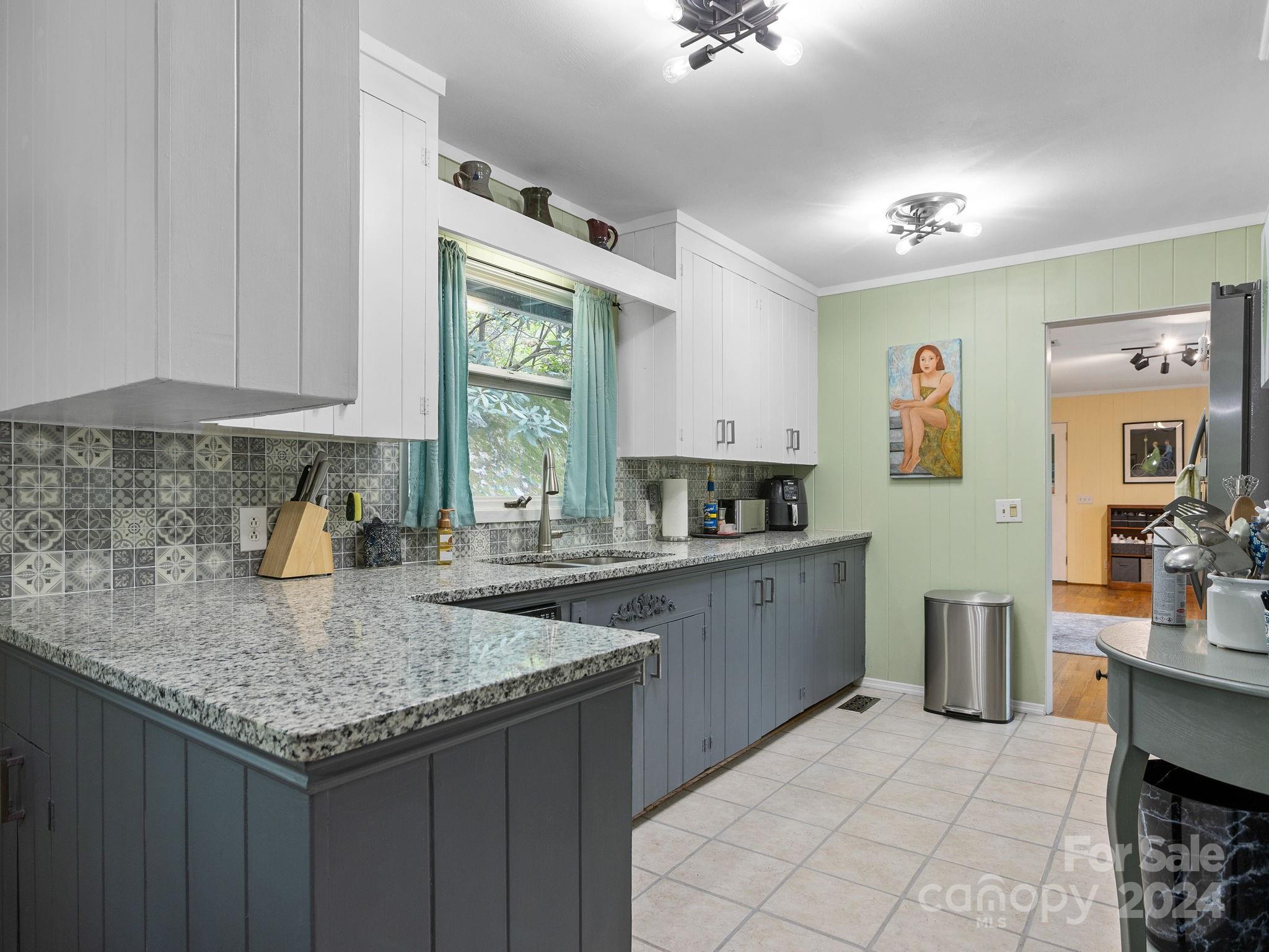 159 Jervey Road Tryon, NC 28782 - Photo 11 of 43 a kitchen with granite countertop a sink and cabinets