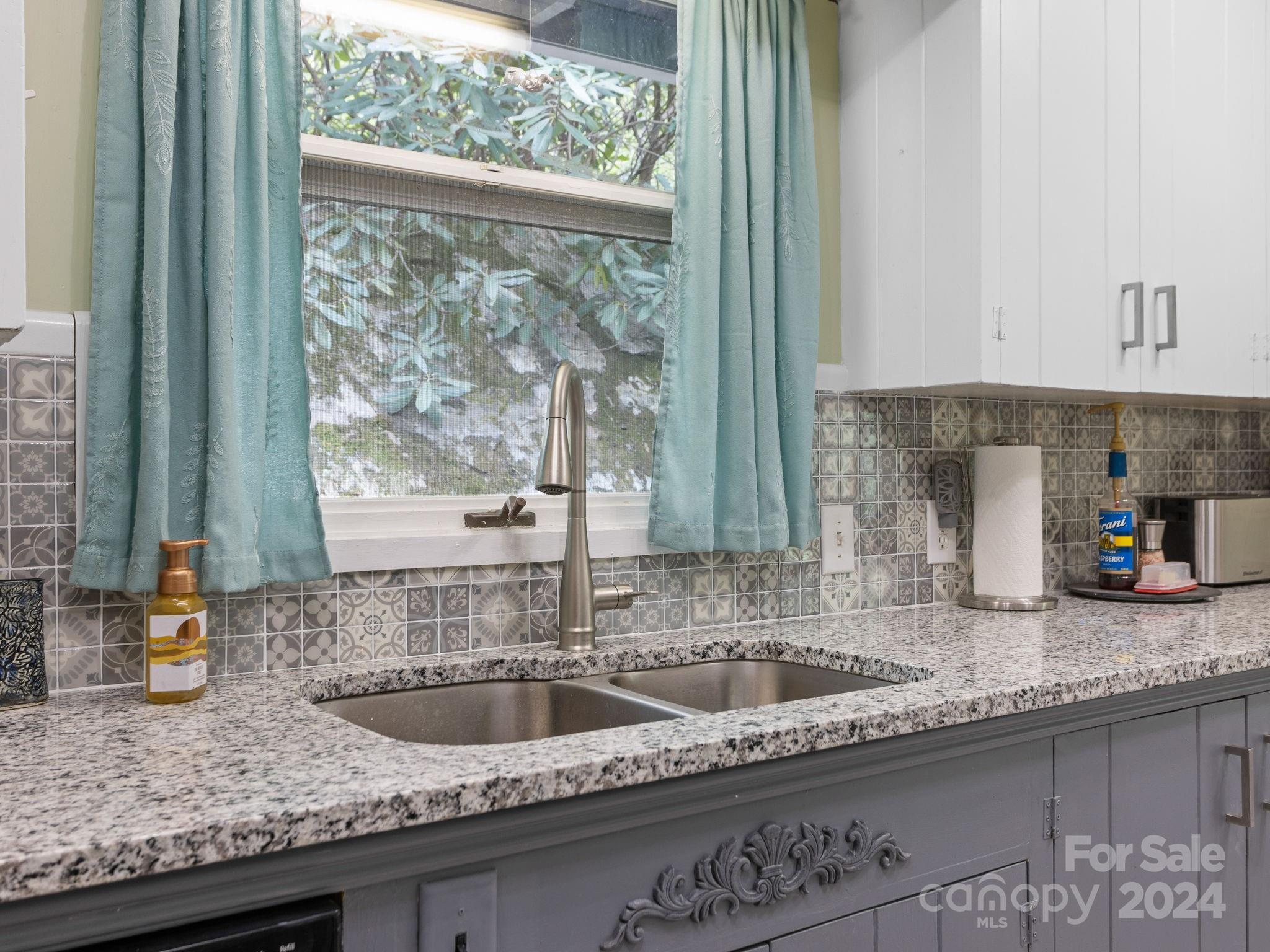 159 Jervey Road Tryon, NC 28782 - Photo 13 of 43 a kitchen with granite countertop a sink and a window