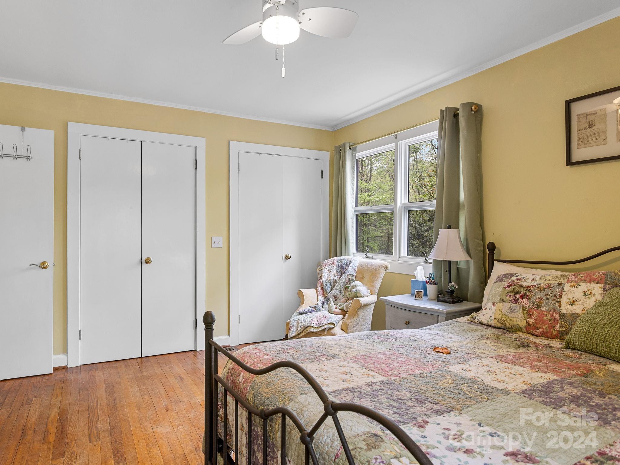 159 Jervey Road Tryon, NC 28782 - Photo 17 of 43 a bedroom with a bed and wooden floor