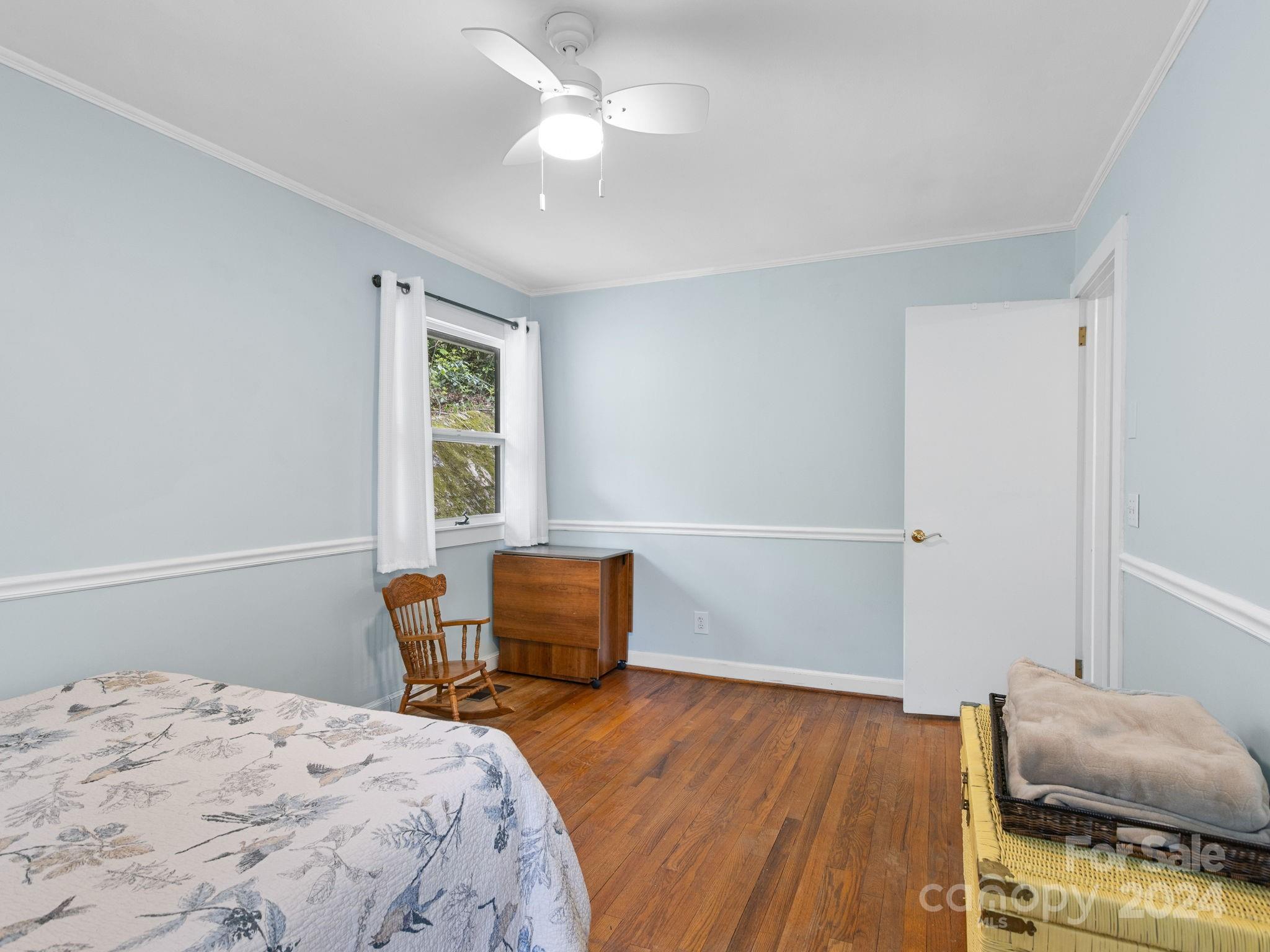 159 Jervey Road Tryon, NC 28782 - Photo 22 of 43 a bedroom with a bed and wooden floor