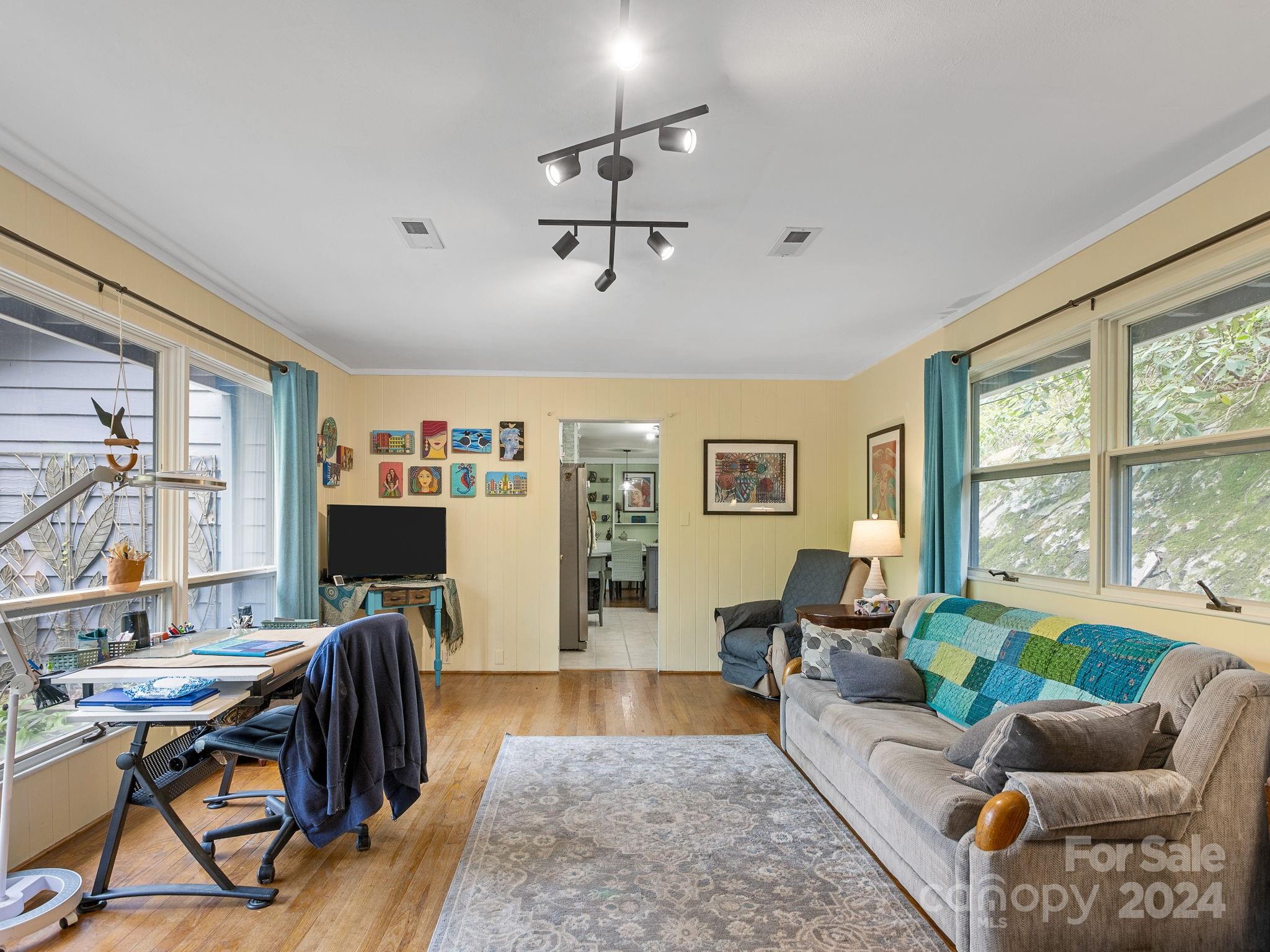 159 Jervey Road Tryon, NC 28782 - Photo 23 of 43 a living room with furniture two window and a flat screen tv