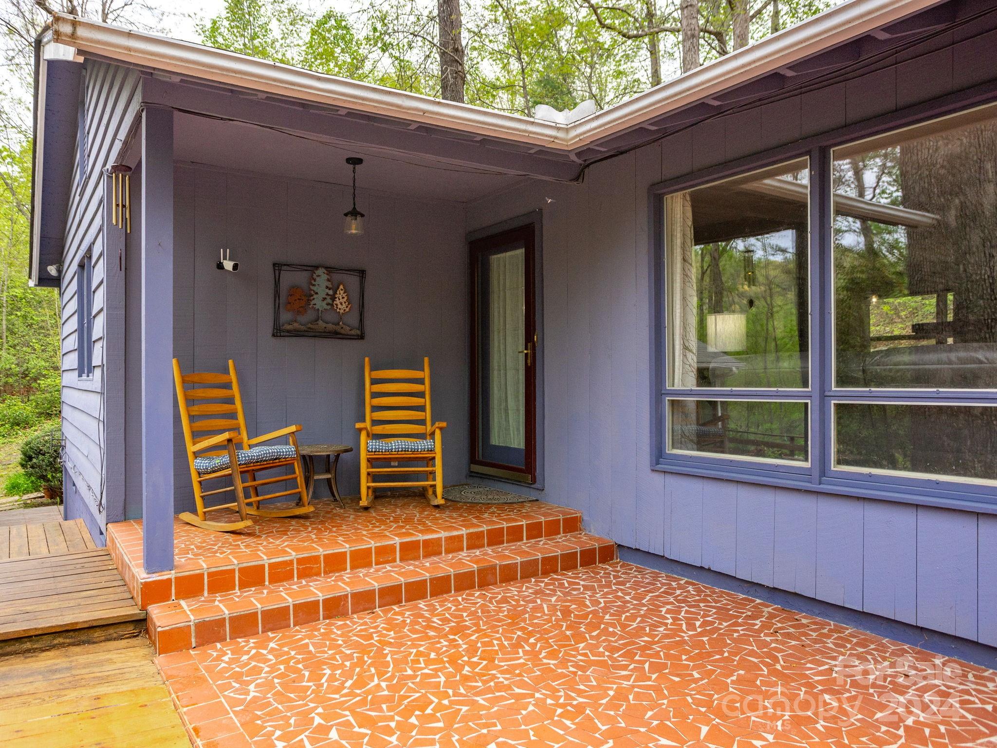 159 Jervey Road Tryon, NC 28782 - Photo 3 of 43 a backyard of a house with barbeque oven table and chairs