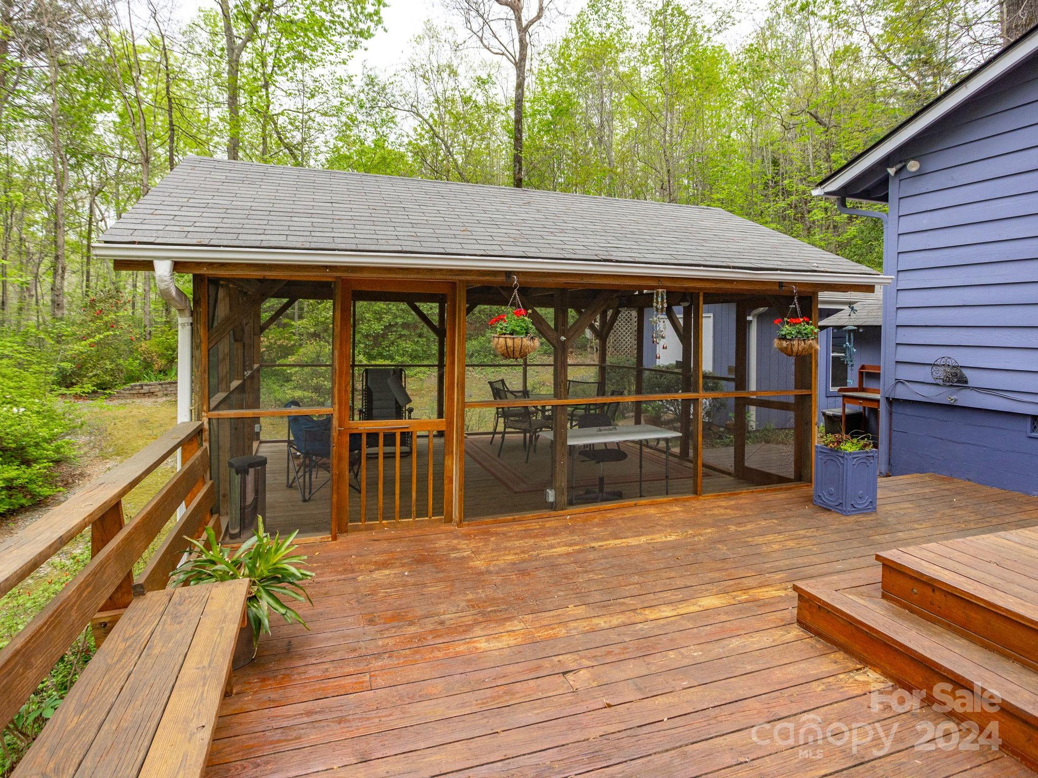 159 Jervey Road Tryon, NC 28782 - Photo 35 of 43 a view of a wooden deck and a patio with table and chairs with wooden floor and fence