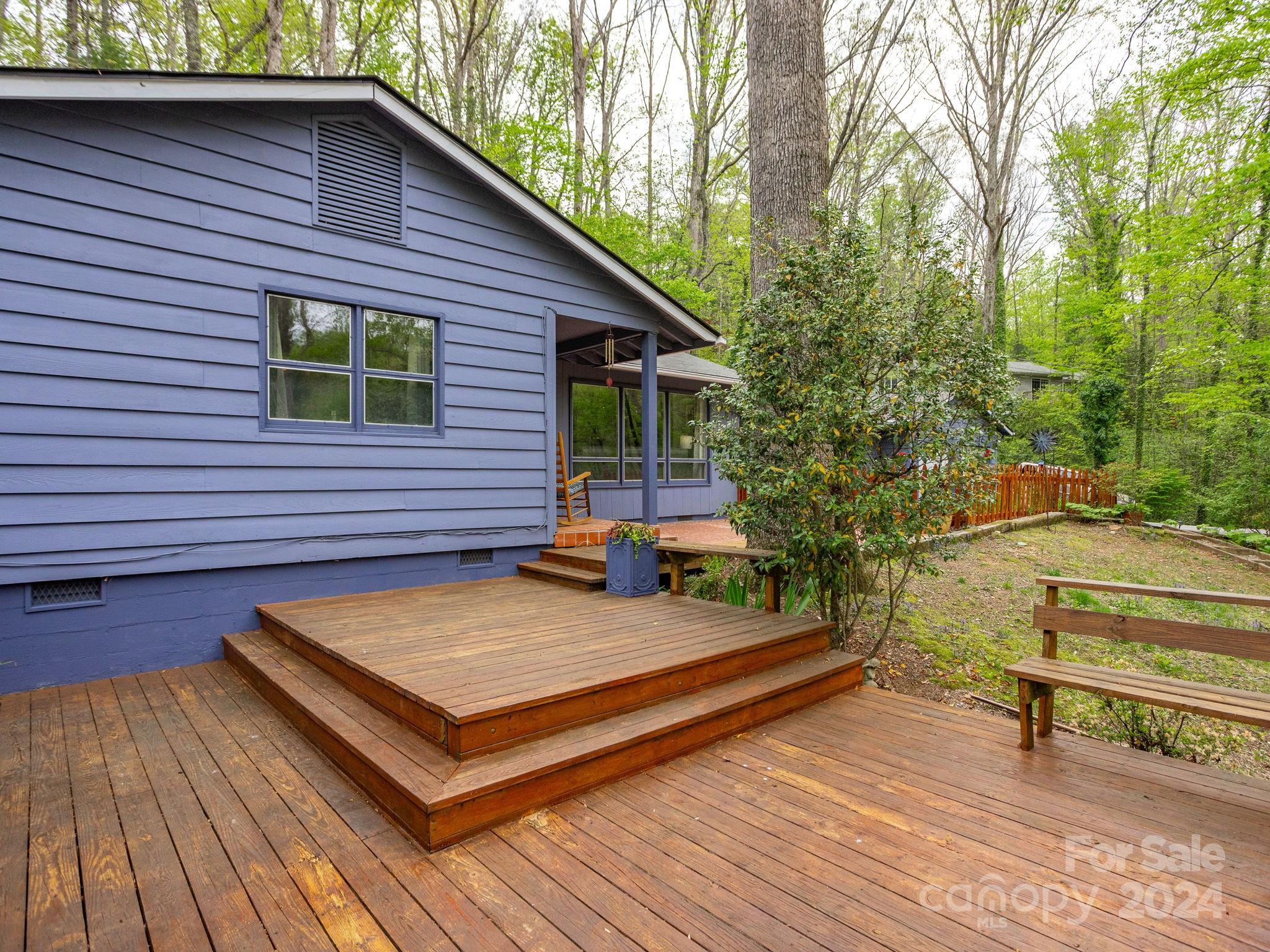 159 Jervey Road Tryon, NC 28782 - Photo 36 of 43 a view of a wooden deck with a bench and trees