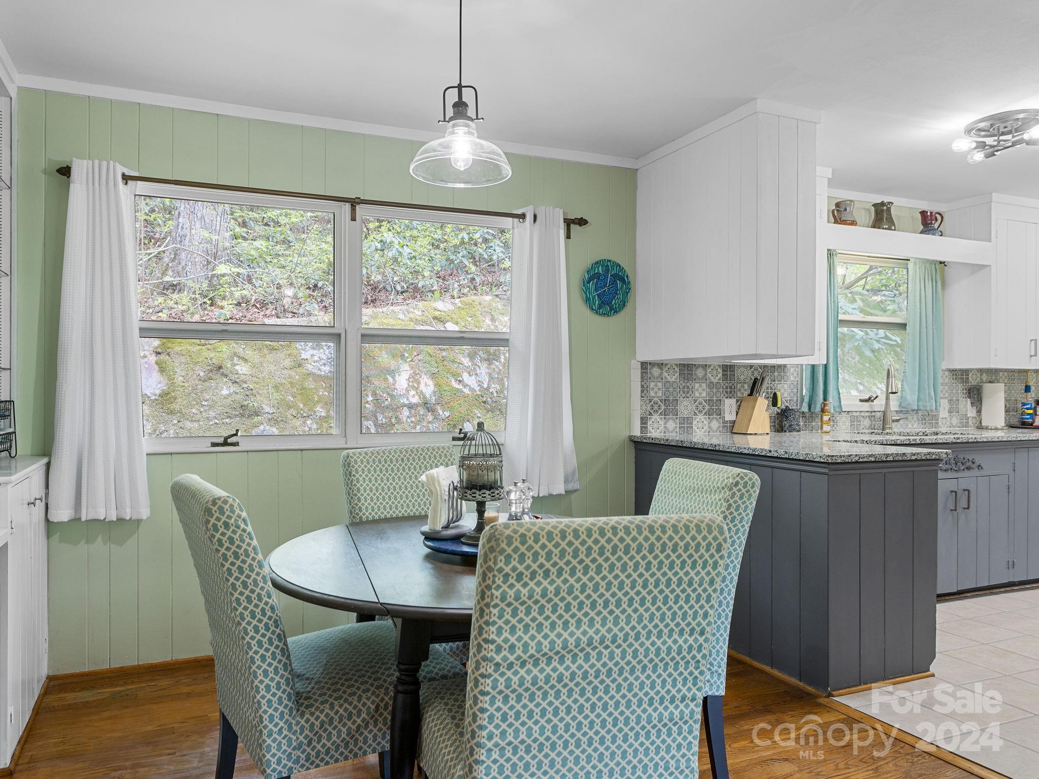 159 Jervey Road Tryon, NC 28782 - Photo 9 of 43 a dining room with furniture a rug and wooden floor