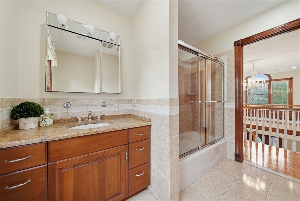 131 Range Heights Road Lynn, MA 01904 - Photo 14 of 36 a bathroom with a sink a mirror a vanity and shower