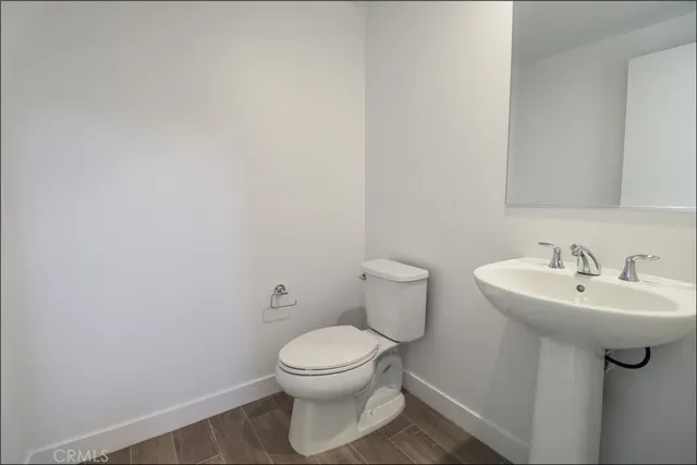 a white toilet sitting next to a bathroom sink