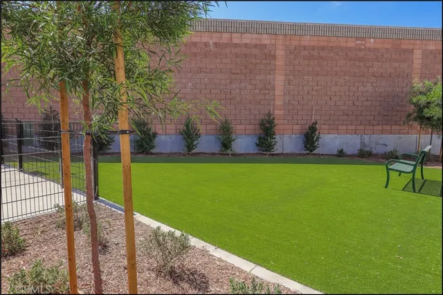 a view of a garden with tall buildings