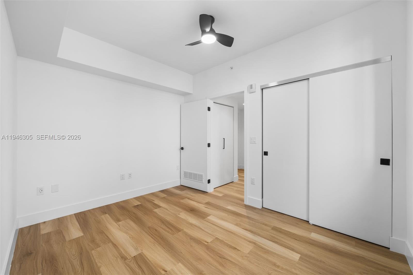 650 Southwest 1st Street, Unit 406 Miami, FL 33130 - Photo 17 of 33 a view of room with hardwood floor and ceiling fan