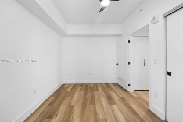 a view of a room with wooden floor and small staircase