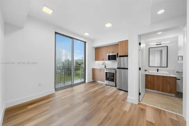 a large kitchen with a lot of counter space and stainless steel appliances
