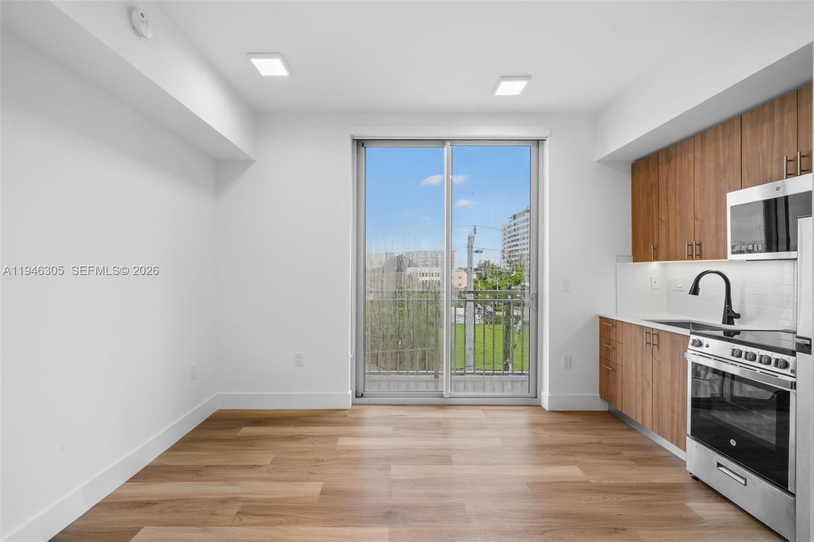 650 Southwest 1st Street, Unit 406 Miami, FL 33130 - Photo 4 of 32 a view of a kitchen with a sink and a fireplace