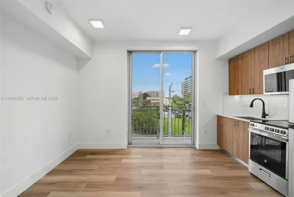 a view of a kitchen with a sink and a fireplace
