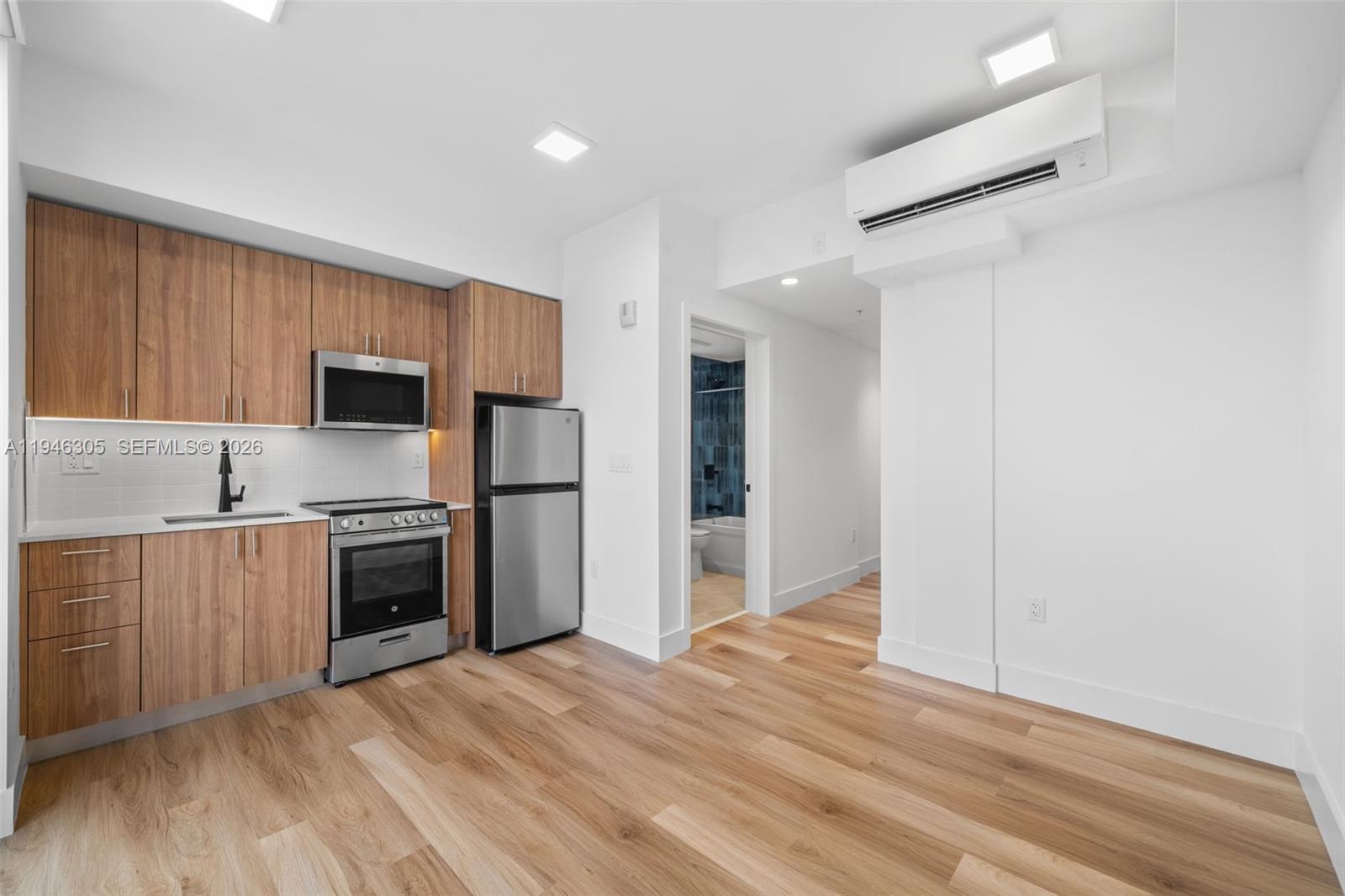 650 Southwest 1st Street, Unit 406 Miami, FL 33130 - Photo 8 of 33 a kitchen with stainless steel appliances granite countertop a refrigerator and a stove top oven