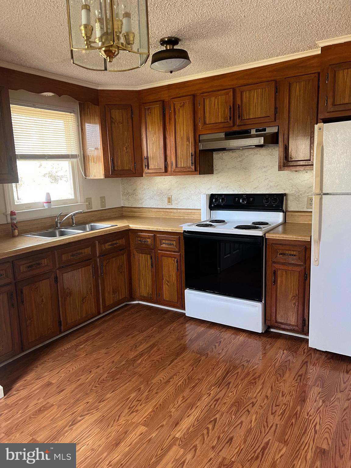 183 North Almond Street, Unit 183 Orange, VA 22960 - Photo 4 of 10 a kitchen with stainless steel appliances granite countertop a sink a stove a refrigerator cabinets and a counter top space