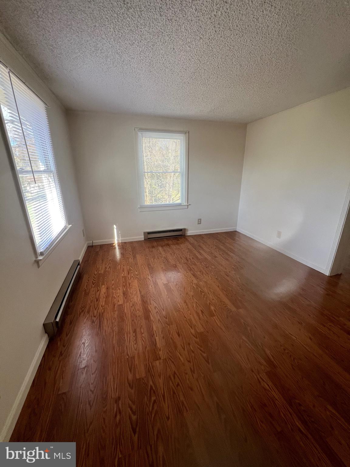 183 North Almond Street, Unit 183 Orange, VA 22960 - Photo 7 of 10 an empty room with wooden floor and windows