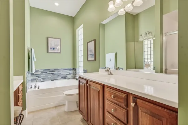 a bathroom with a sink vanity mirror and toilet