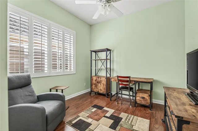 an aerial view of a house with a yard and tennis court