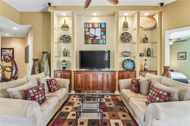 a room with lots of furniture and flat screen tv