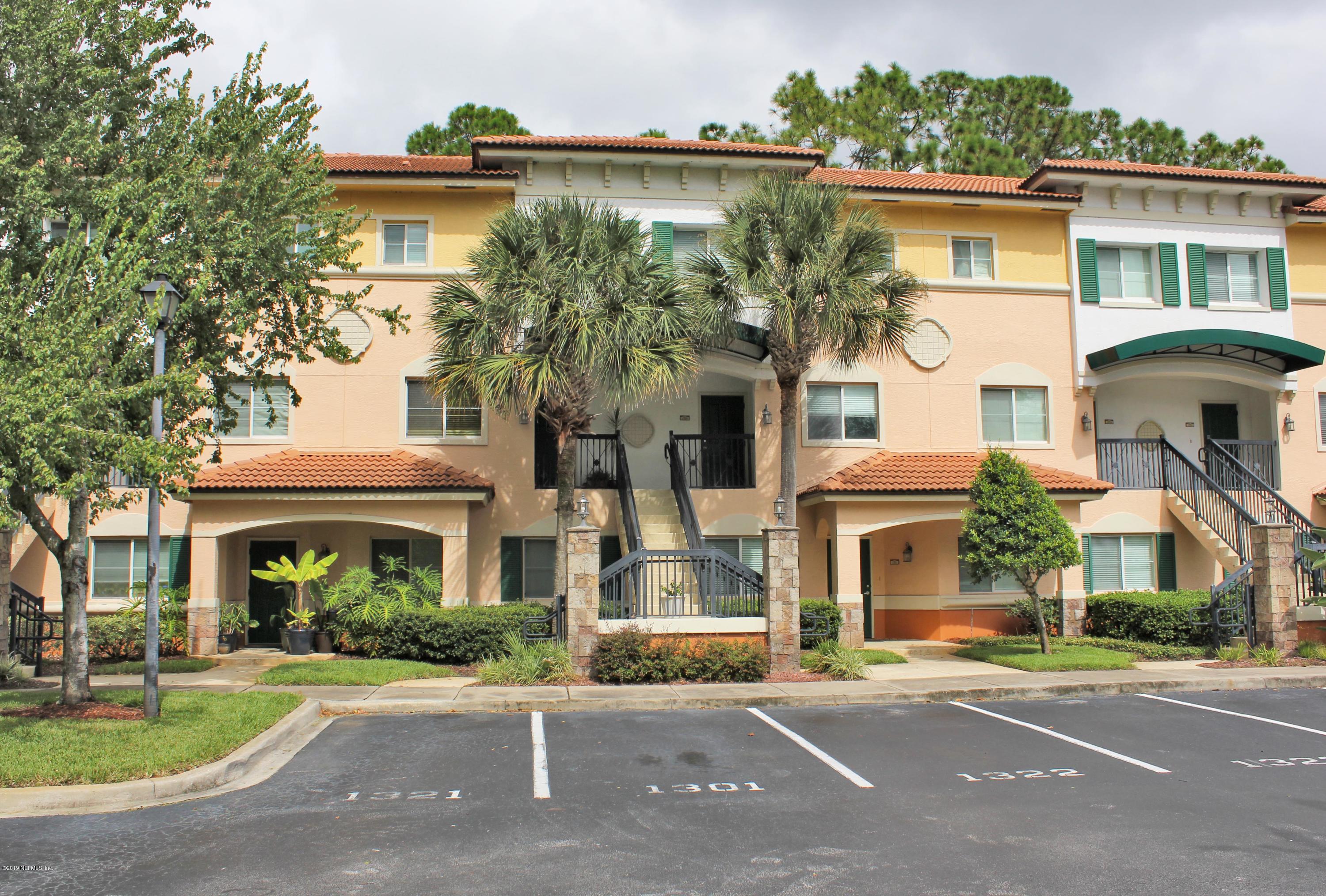 9745 Touchton Road, Unit 1323 Jacksonville, FL 32246 - Photo 1 of 19 a front view of a house with a garden and plants