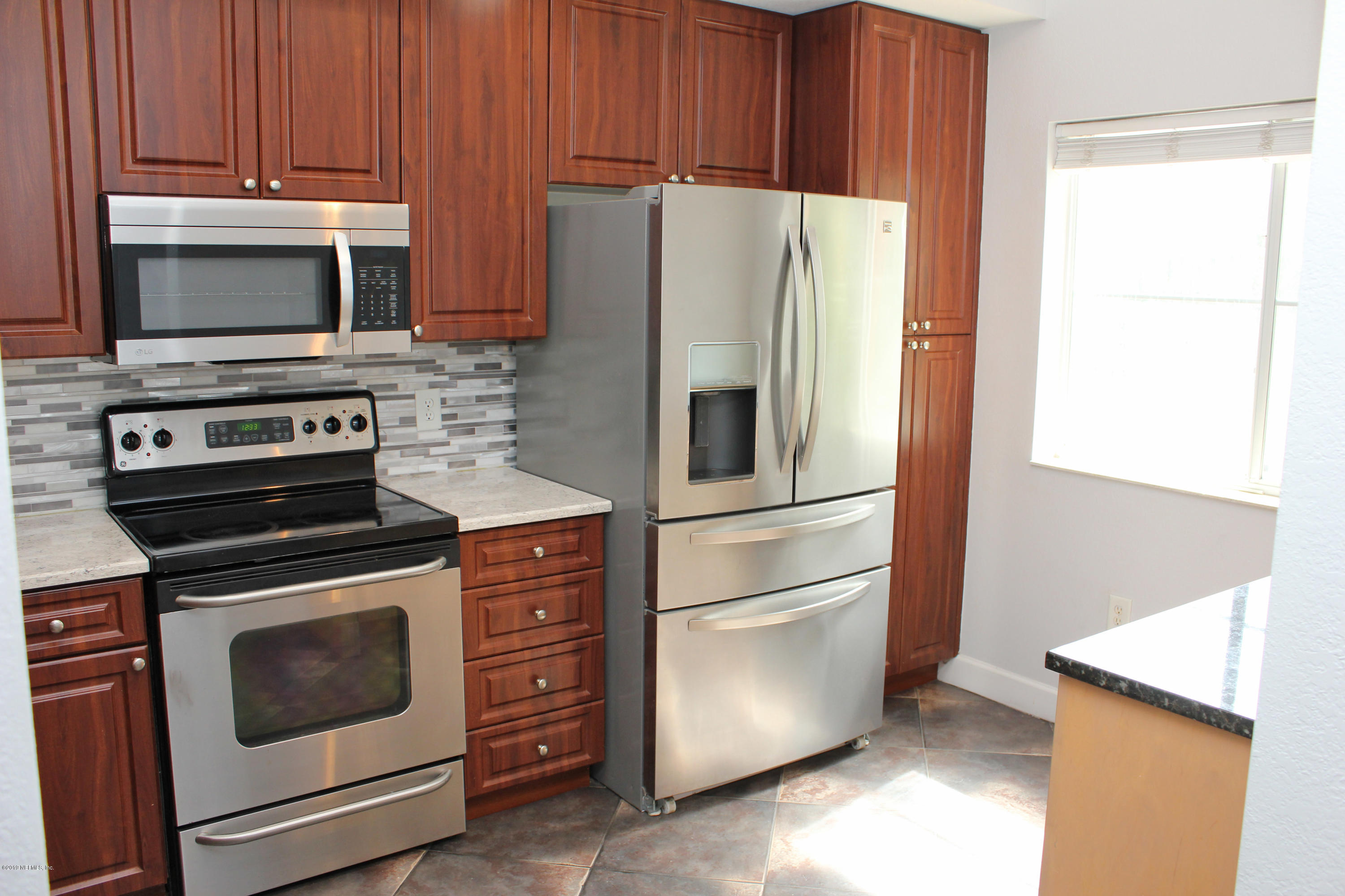 9745 Touchton Road, Unit 1323 Jacksonville, FL 32246 - Photo 4 of 19 a kitchen with appliances and cabinets