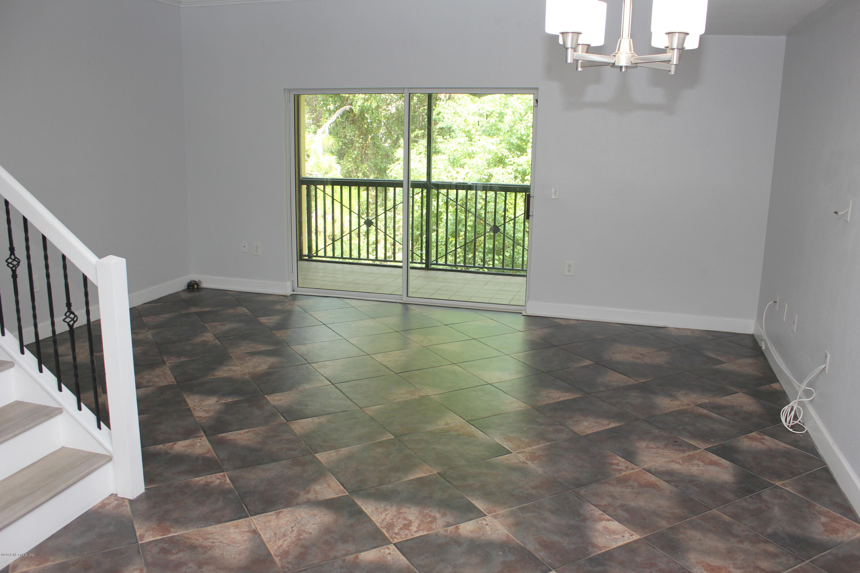 9745 Touchton Road, Unit 1323 Jacksonville, FL 32246 - Photo 7 of 19 a view of an empty room with a window