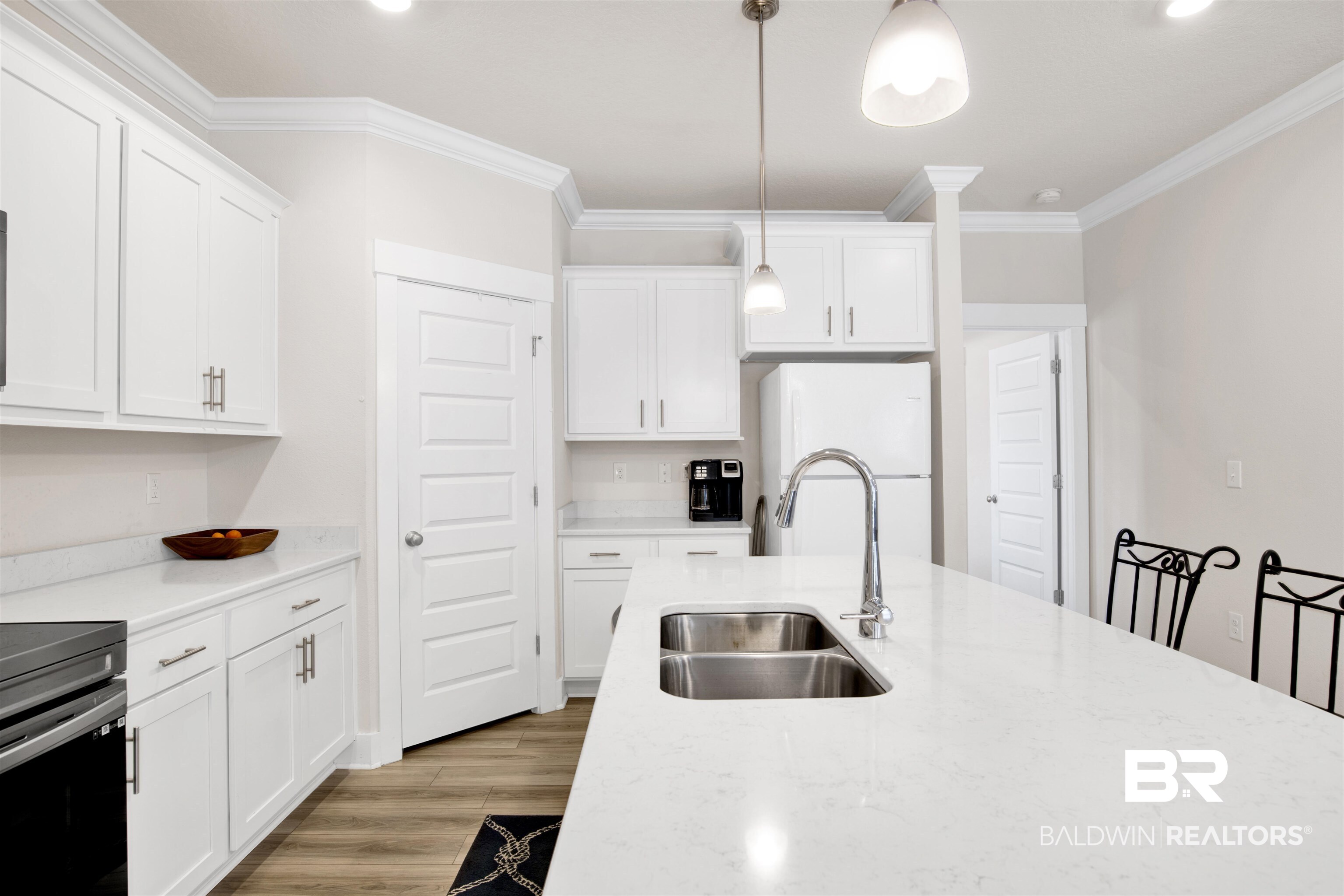 1174 Pheasant Circle Foley, AL 36535 - Photo 13 of 29 Kitchen with freestanding refrigerator, white cabinetry, decorative light fixtures, ornamental molding, and light wood-style flooring