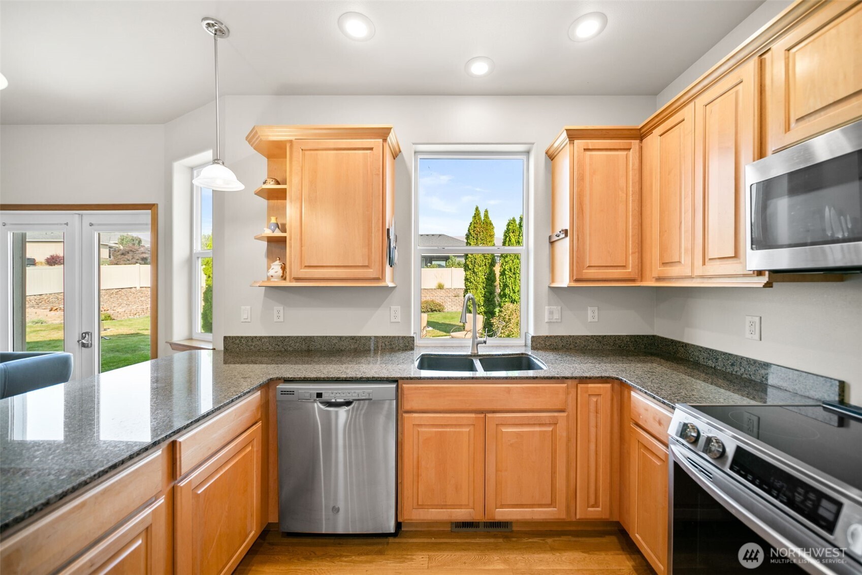 194 Lilly Lane Wenatchee, WA 98801 - Photo 16 of 37 a kitchen with stainless steel appliances granite countertop a sink a stove a refrigerator cabinets and wooden floor