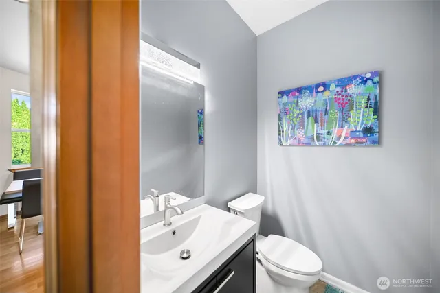 a white toilet sitting next to a bathroom sink