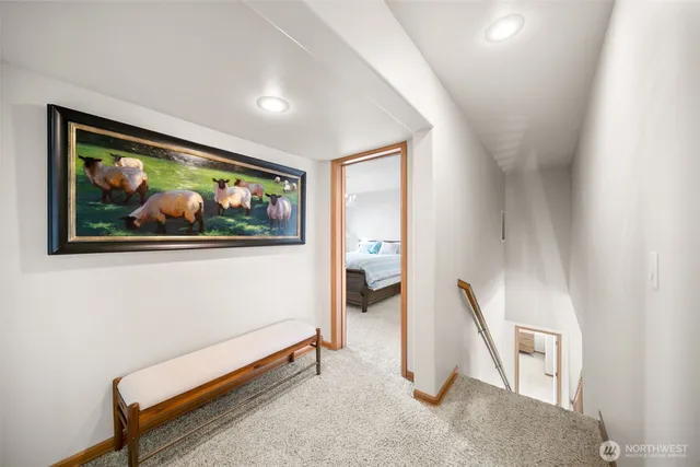 a living room with couch and a painting on the wall