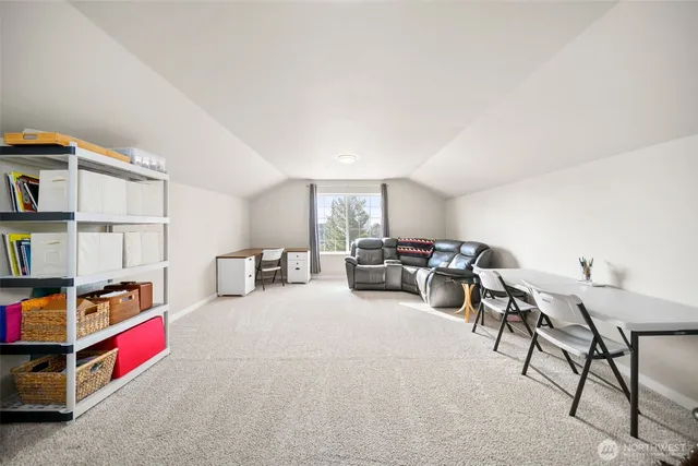 a living room with furniture a flat screen tv and a book shelf