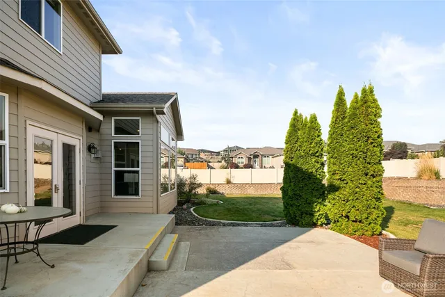 a view of a backyard with sitting area