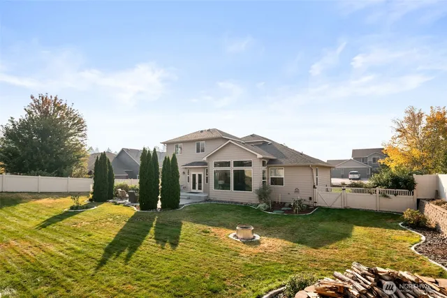 a view of a house with swimming pool and a yard
