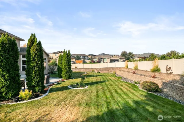 a view of swimming pool with outdoor seating and plants in the back