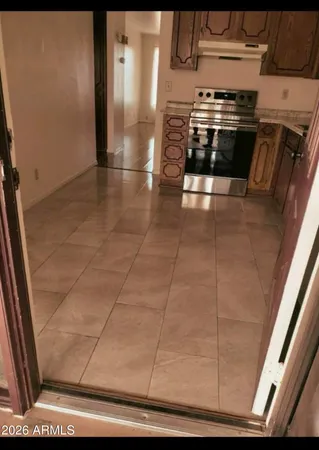 a view of kitchen with stainless steel appliances wooden floor