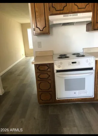 a stove top oven sitting inside of a kitchen