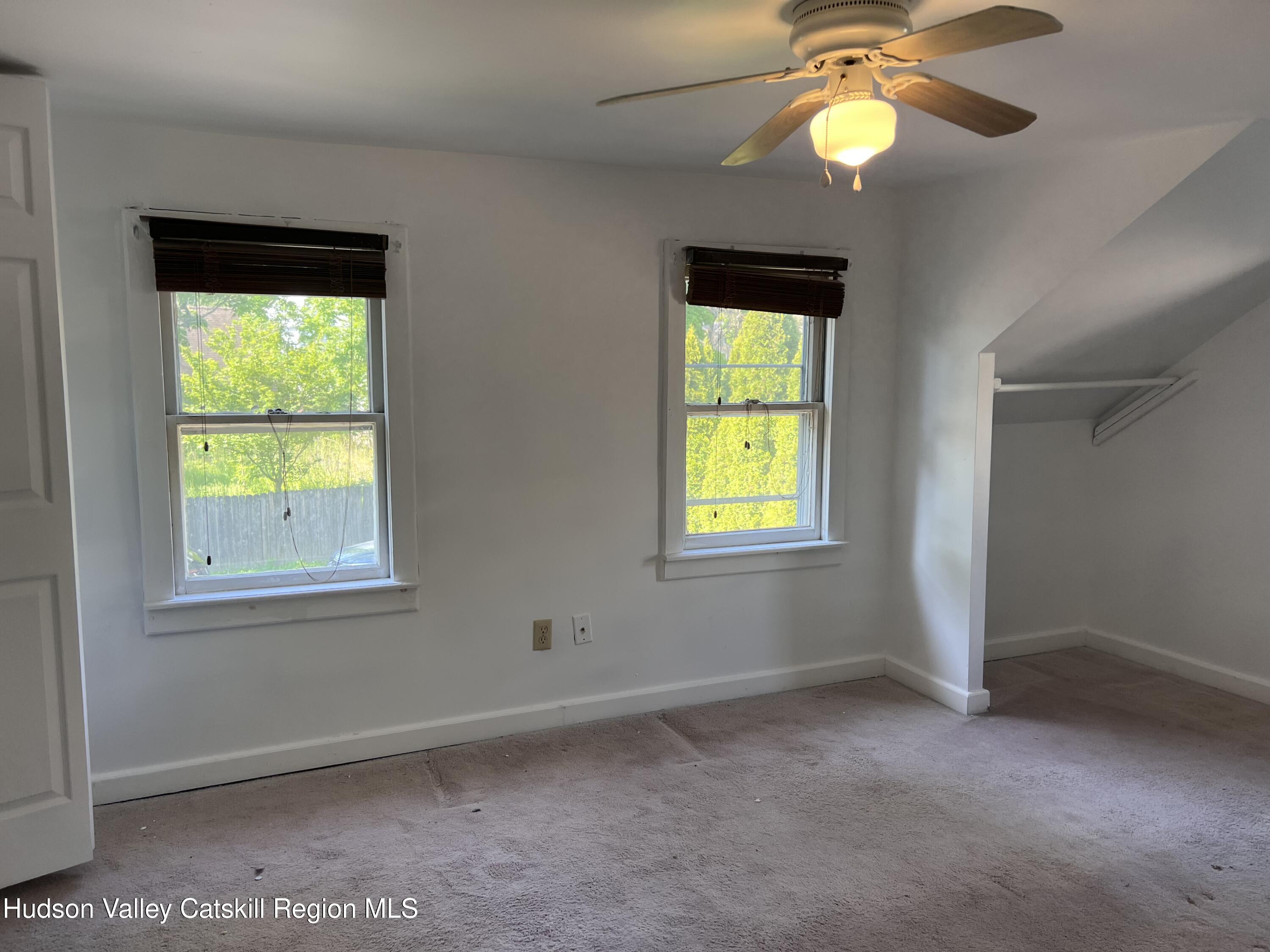 7 Berry Street Wallkill, NY 12589 - Photo 3 of 7 an empty room with a window and a mirror