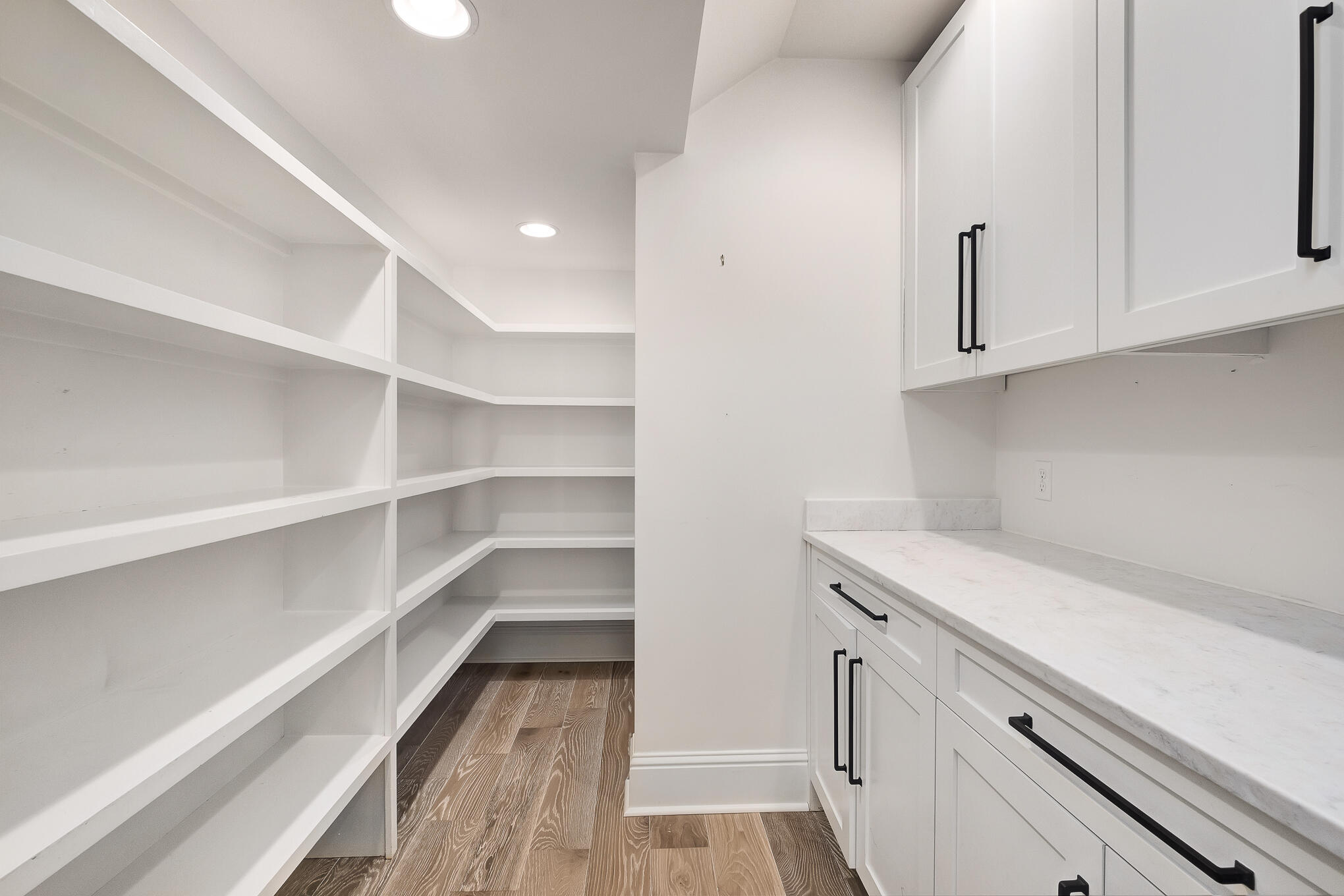 29 Bennett Santa Rosa Beach, FL 32459 - Photo 18 of 78 a view of a kitchen with white cabinets and a wooden floor