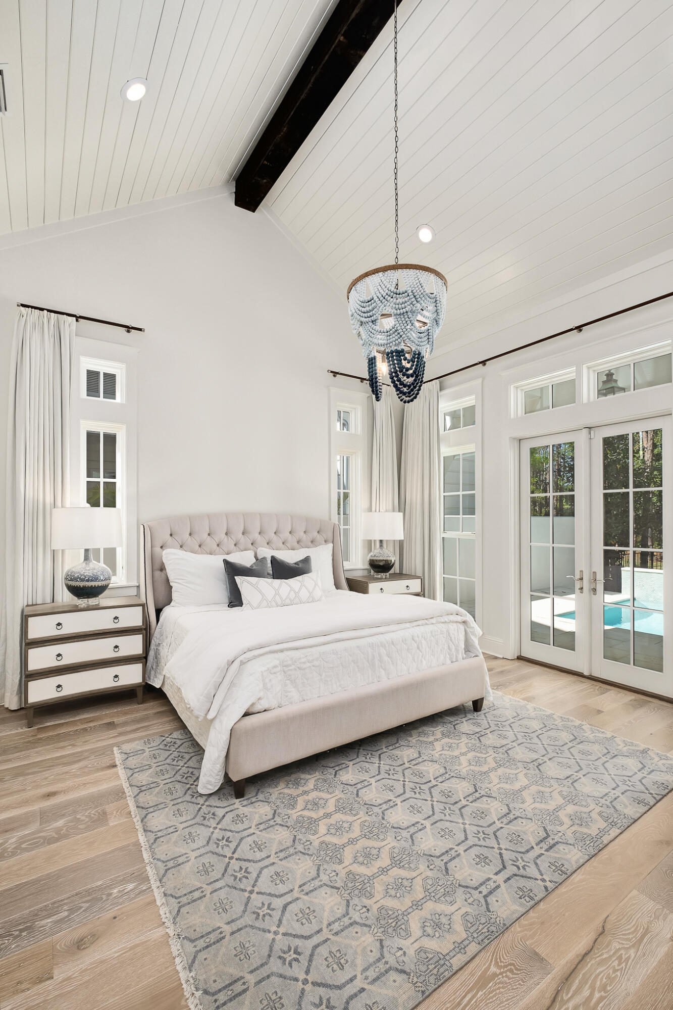 29 Bennett Santa Rosa Beach, FL 32459 - Photo 39 of 78 a spacious bedroom with a large bed and a chandelier