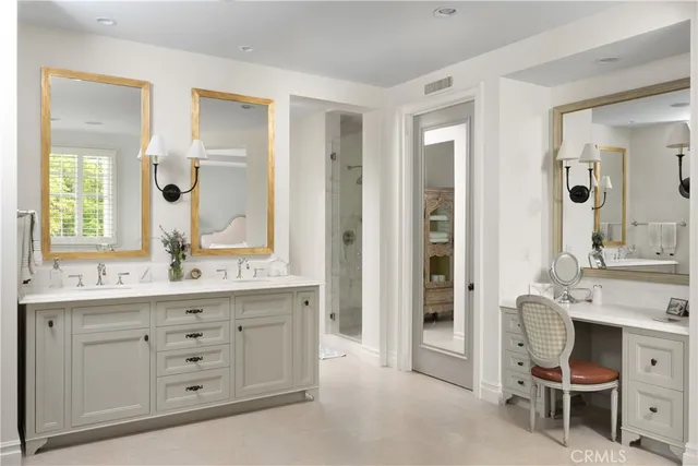 a spacious bathroom with a double vanity sink a mirror and a shower